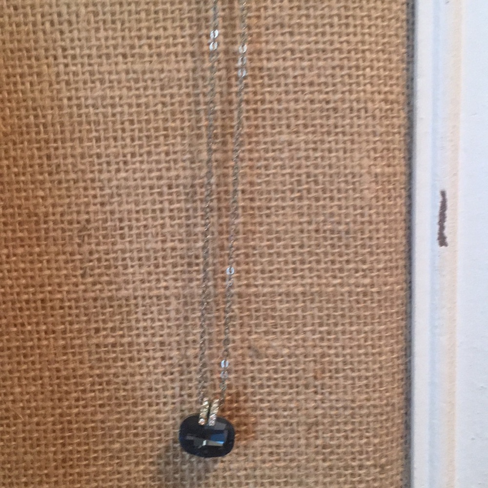 Blue stone with crystal accents on a chain.